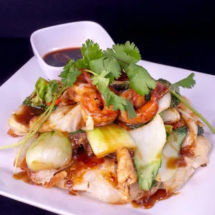 Combination stir fry over pan crisped rice noodles