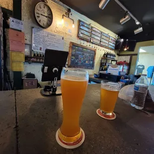 two glasses of beer on a table