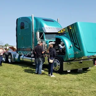 people standing around a large semi truck