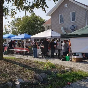 a group of people standing under tents