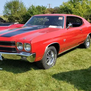 the front end of a red muscle car