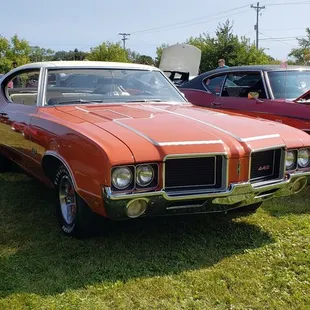 a row of classic cars at a car show