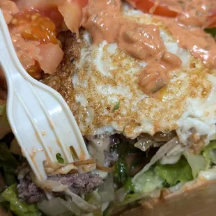 Single patty burger with egg and vegetables minus the bun.