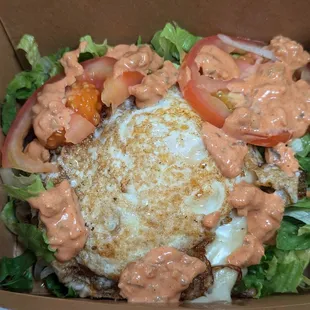 Single patty burger with egg and vegetables minus the bun.