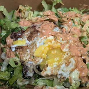 Single patty burger with egg and vegetables minus the bun.