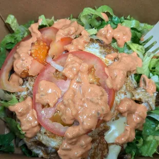 Single patty burger with egg and vegetables minus the bun.