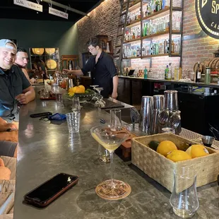 a bar counter with wine glasses and lemons