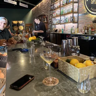 a bar counter with wine glasses and lemons