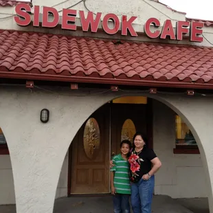 two people standing in front of the entrance