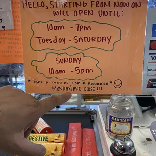 a hand holding a sign that says hello starting from now