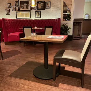 a dining area with a table and chairs