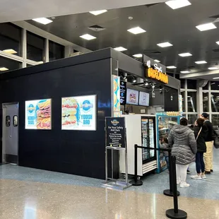 people standing in line at the check - in area