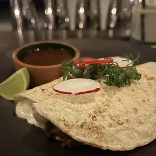 a tortilla on a black plate