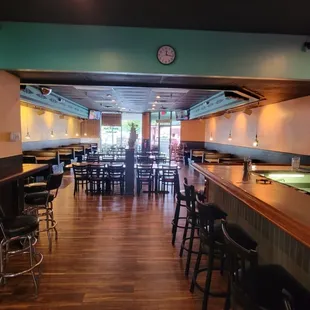 a bar with a clock on the wall