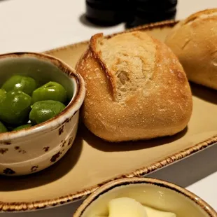 bread, olives and butter on a plate