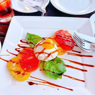 1 ball of cheese, 4 slices of tomato with 2 basil leaves for $18.5