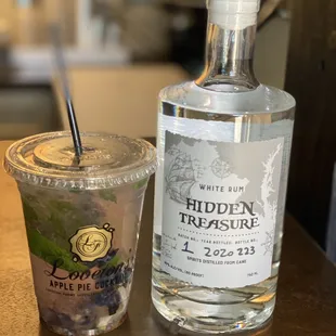 a bottle of hidden treasure and a drink