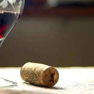 a glass of wine and a cork