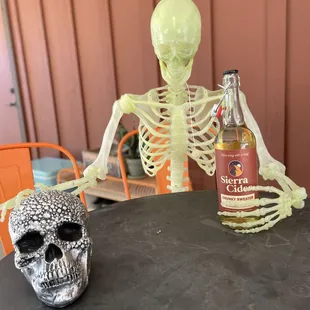 a skeleton holding a bottle of sierra cid