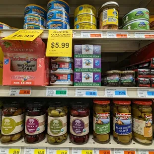 Cute tiny jars of anchovies for a single serving .