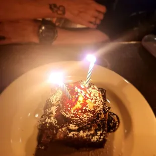 Chocolate birthday cake with a scoop of vanilla ice cream