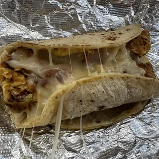 Migas breakfast taco with crunchy tortilla chips, oozing with delicious cheese.