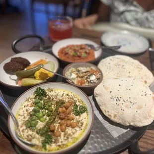 Platter with Charred Chickpea Hummus, Falafel, pita bread, Side Muhammara, Eggplant and Pickles