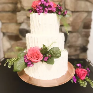 Three tier wedding cake with pink roses