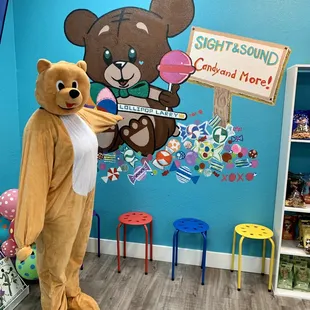 a teddy bear holding a sign