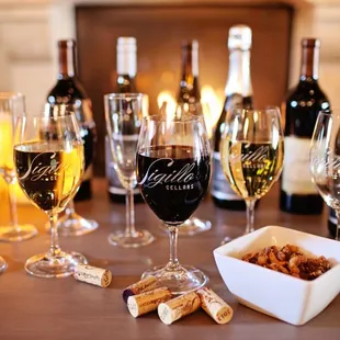 a table with wine glasses and wine corks