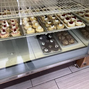 a variety of pastries in a display case