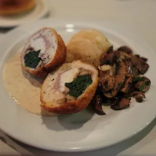 Stuffed chicken with mushrooms and scalloped potatoes.