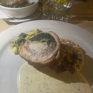 Stuffed chicken breast with bacon and mushroom risotto and broccoli with cheddar truffle fondue