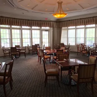 a large dining room with tables and chairs