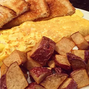 The signature of omelette w/ home fries &amp; wheat toast $7.95