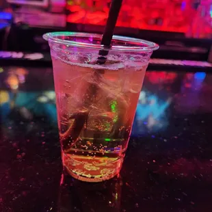 a drink in a plastic cup with a straw