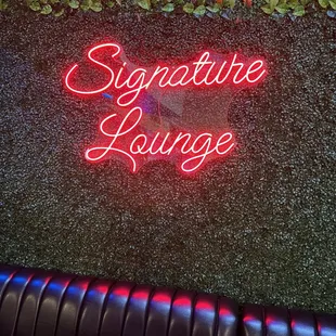 a neon sign on the wall