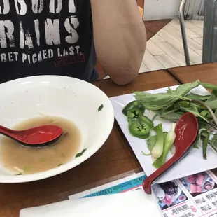 a bowl of soup and a plate of vegetables