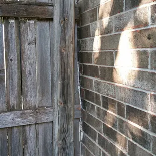 Gash in house due to tree pushing on fence to house