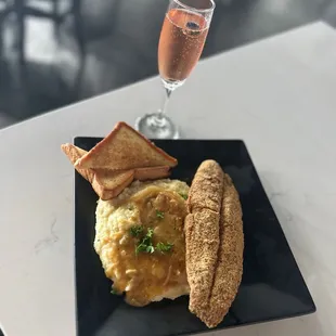 a plate of food and a glass of wine