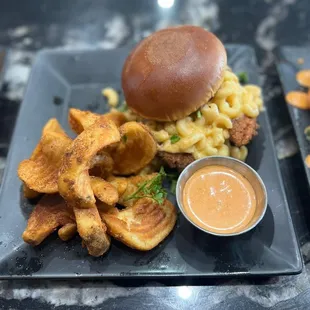 a burger with macaroni and cheese fries