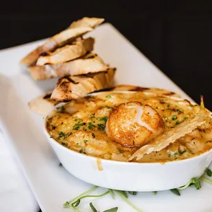 Baked Seafood Artichoke Dip with roasted artichoke, spinach, Parmigiano-Reggiano, herbs, shrimp, langostino, and scallops