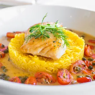 Poached halibut, Tomato consommé, shallot, garlic, fresh tomato, caper, pepper, and saffron rice