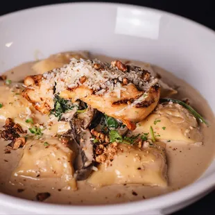 Butternut Agnolotti: Roasted butternut squash filled with Agnolotti, spinach, portebella, walnuts, marsala cream, and parmesan