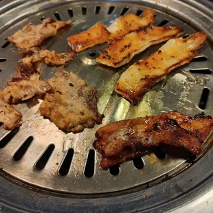 a variety of meats on a grill