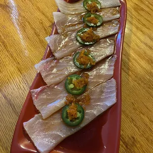 a long rectangular platter of sliced fish