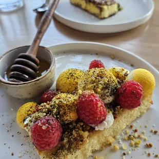 "Honey Bee" dessert.  Grilled semolina cake with charred raspberries, panna cotta, pistachio/bee pollen crumble and fresh local honey!