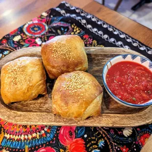 bread rolls and a bowl of tomato sauce