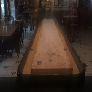 a shuffle table in the middle of the room