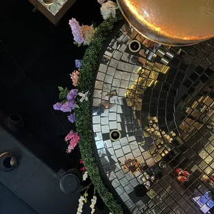 The bar ceiling was decorated in flowers, greenery, and bird ornaments